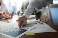 Double exposure of businessman hand working with new modern computer and business strategy as concept